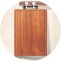 Wooden cutting board with two hooks on a white background