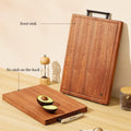 Two wooden cutting boards with a pepper grinder and avocado on a light wood surface.