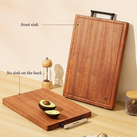 Two wooden cutting boards with a pepper grinder and avocado on a light wood surface.