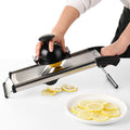Hand slicing lemon with adjustable stainless steel mandoline slicer
