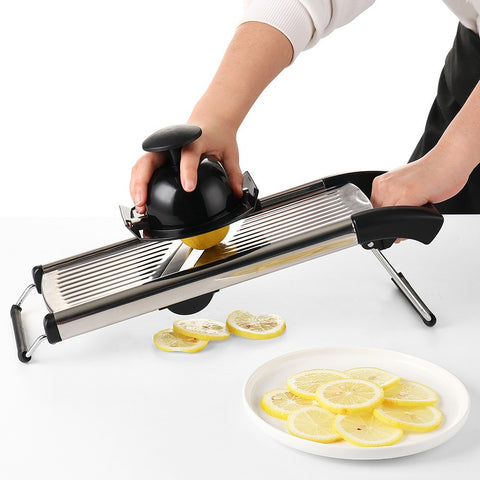Hand slicing lemon with adjustable stainless steel mandoline slicer
