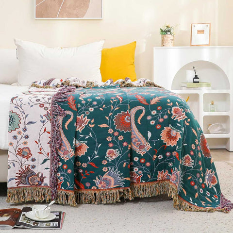 Amira reversible throw blanket draped over sofa with tassel fringe