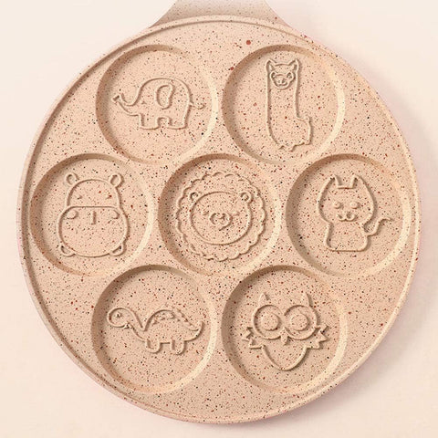 Top view of pink Animals Waffle and Pancake Pan showing playful animal smiley face molds on a neutral background