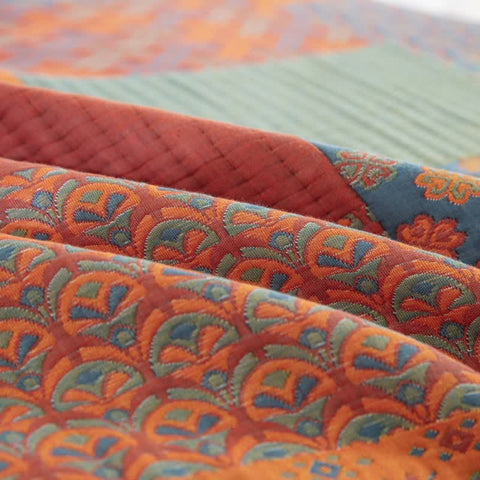 Detailed edge stitching and colorful pattern on cotton quilt