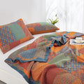 Quilt and pillow detail showing colorful patchwork patterns