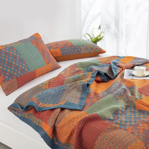 Quilt and pillow detail showing colorful patchwork patterns