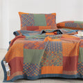 Reversible cotton quilt with pillowcases in orange, blue, and green tones