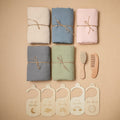 Organic cotton baby towel set with brush, comb, and growth chart markers