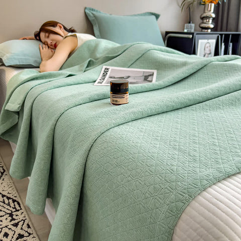  Balance Grid Cotton Muslin green Quilt neatly displayed on bed in minimalist bedroom