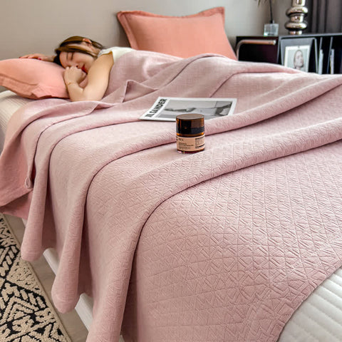 Pink cotton muslin quilt with subtle grid texture