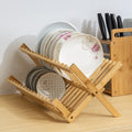 Wooden dish rack with plates on a kitchen counter