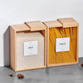 Wooden storage boxes labeled 'Rice' and 'Pasta' on a gray surface.