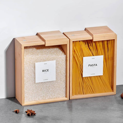 Wooden storage boxes labeled 'Rice' and 'Pasta' on a gray surface.