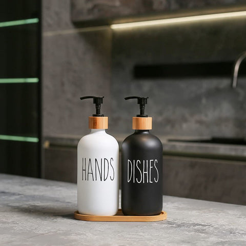 Two soap dispensers labeled 'HANDS' and 'DISHES' on a kitchen counter.