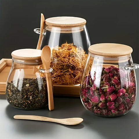 Glass jars with wooden lids and spoons containing various herbs and spices on a dark background