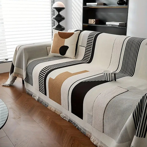 Neutral beige sofa cover with black line pattern in cozy modern interior