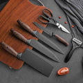 Premium black kitchen knife set with wood grain handles, scissors, and peeler on cutting board
