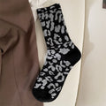 Black leopard sock flat lay 