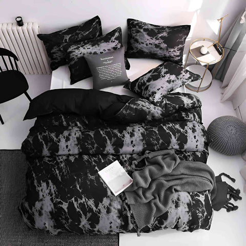 Decorative pillows and duvet on queen bed with modern decor