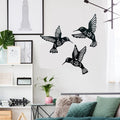 Black bird wall decals on a white wall in a living room setting.