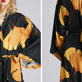 Black satin kimono-style robe with golden ginkgo leaf print, loose fit, and waist tie—stylish luxury loungewear for home, spa, or vacation.