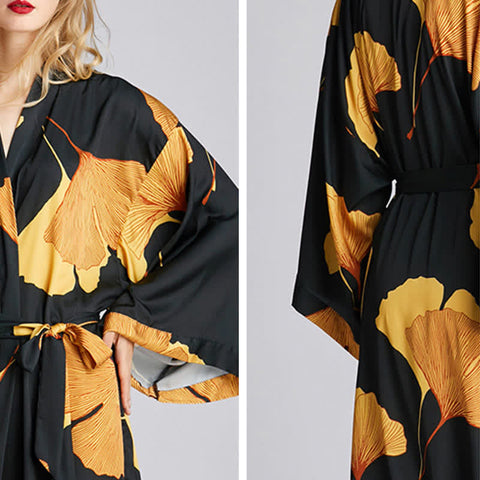 Black satin kimono-style robe with golden ginkgo leaf print, loose fit, and waist tie—stylish luxury loungewear for home, spa, or vacation.