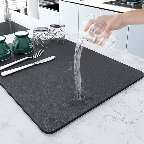 Water being poured on black dish drying mat showing hydrophobic surface
