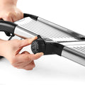 Close-up of blade adjustment on stainless mandoline slicer
