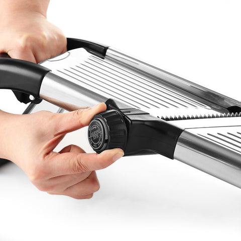 Close-up of blade adjustment on stainless mandoline slicer
