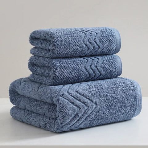 Blue cotton towel set with hand and bath towels stacked