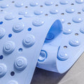 Raised suction cup texture on bottom of light blue shower mat

