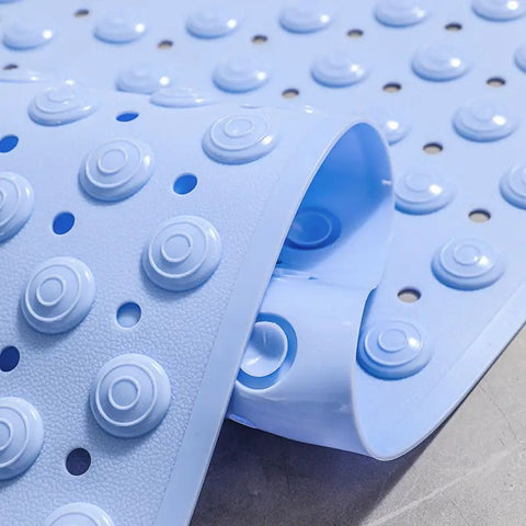 Raised suction cup texture on bottom of light blue shower mat

