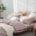 Blush Pink Waffle Bedding Set with Cream Throw on Low Wooden Bed – Cute and Cozy Dorm Room Bedding Idea