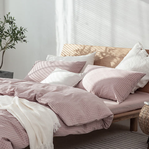 Blush Pink Waffle Bedding Set with Cream Throw on Low Wooden Bed – Cute and Cozy Dorm Room Bedding Idea