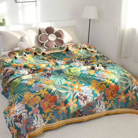 Bohemian floral cotton throw blanket with tropical design spread on bed with beige pillows and soft natural light filtering through window