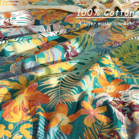 Close-up detail of bohemian floral cotton throw blanket showing vibrant tropical patterns and soft texture under natural light