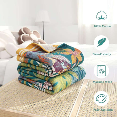 Folded bohemian floral cotton throw blanket on bedside table highlighting skin-friendly, machine washable, and fade-resistant features