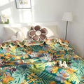 Bohemian tropical floral throw blanket spread on bed with beige pillows and cozy decor in bright, sunlit room
