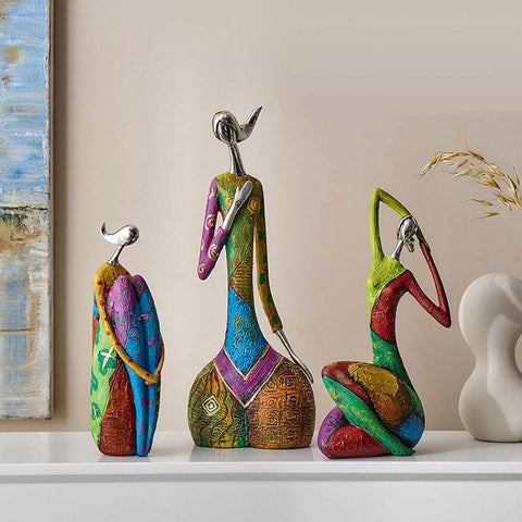 Colorful abstract sculptures on a shelf with a neutral background