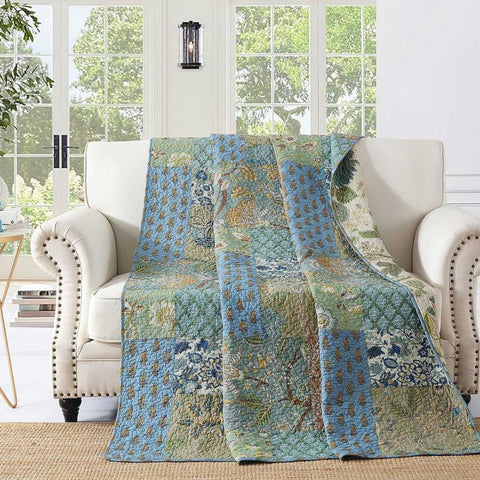 Bohemian reversible quilt draped on ivory armchair in bright room