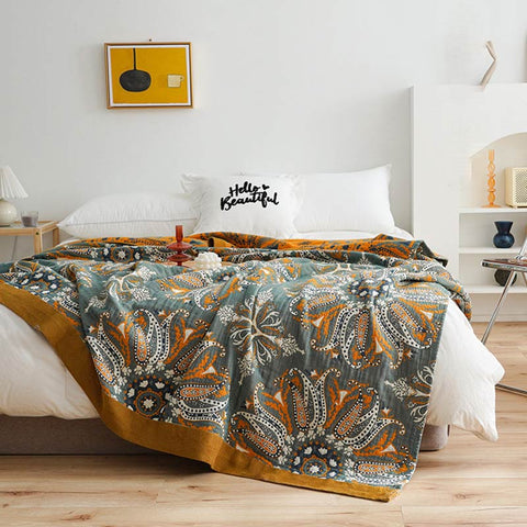 Double bed covered with boho reversible quilt and wooden tray