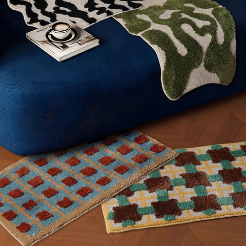 Assorted bath mats styled in modern bathroom with coffee table book