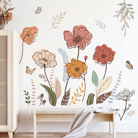 Floral wall decals on a white wall with a wooden bench and cabinet.