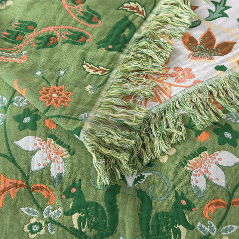 Close-up of a green fabric with floral patterns and tassels