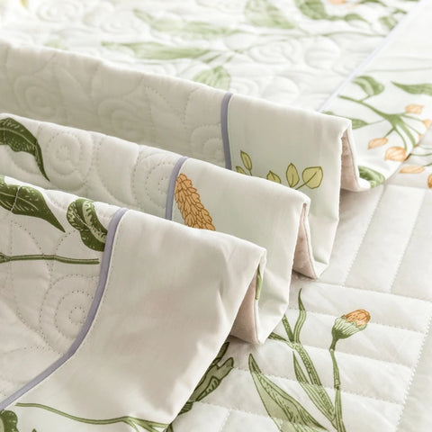  Folded cotton quilt and pillowcases showing detailed trim and softness