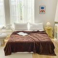 Minimalist bedroom with brown butterfly throw blanket styled as couch or bed cover