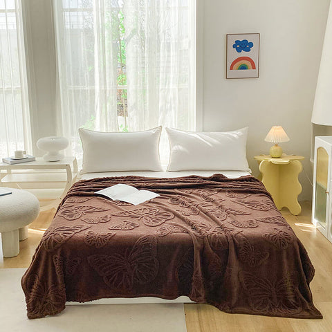 Minimalist bedroom with brown butterfly throw blanket styled as couch or bed cover