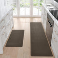 Two brown kitchen mats on a wooden floor with white cabinets and appliances in the background.