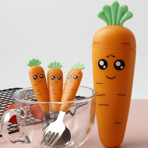 Carrot baby fork and spoon standing in clear glass