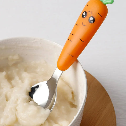 Adorable carrot handle spoon in baby food bowl